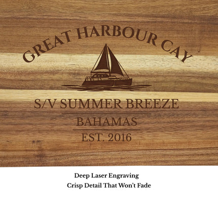 Close up of Great Harbour Cay Bahamas sailboat cutting board engraving showing detailed sailboat design and acacia wood grain
