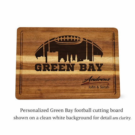 Custom Green Bay football cutting board with dark laser engraved skyline and personalized name shown on a white background
