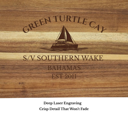 Close up of Green Turtle Cay Bahamas sailboat cutting board engraving showing detailed sailboat design and acacia wood grain
