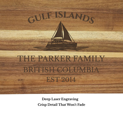 Close up of Gulf Islands British Columbia sailboat cutting board engraving showing detailed sailboat design and natural acacia wood grain