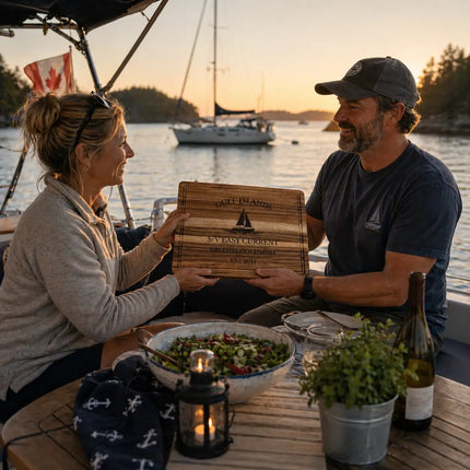 Gulf Islands British Columbia personalized cutting board being shared between sailors on a sailboat at anchor during a relaxed evening in calm protected waters