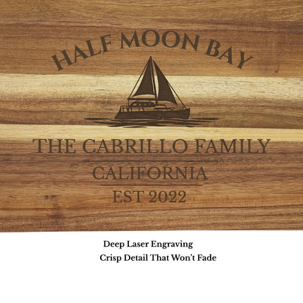 Close up of Half Moon Bay California sailboat cutting board engraving showing detailed laser etched sailboat design and acacia wood grain