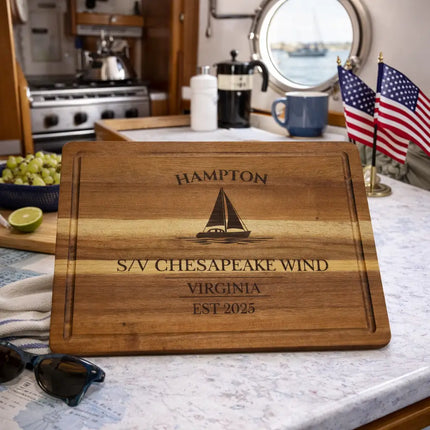 Hampton Virginia personalized sailboat cutting board displayed in a sailboat galley with Chesapeake Bay coastal setting