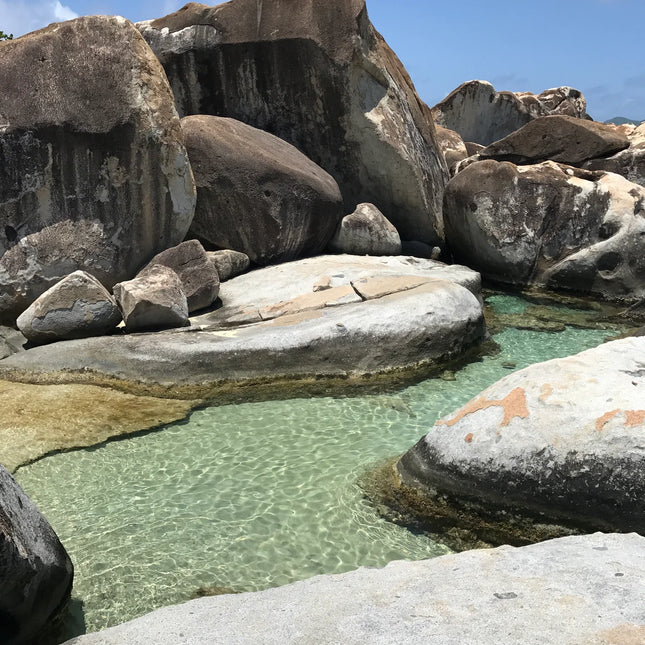 Clear natural pool surrounded by massive rounded granite boulders at The Baths on Virgin Gorda.