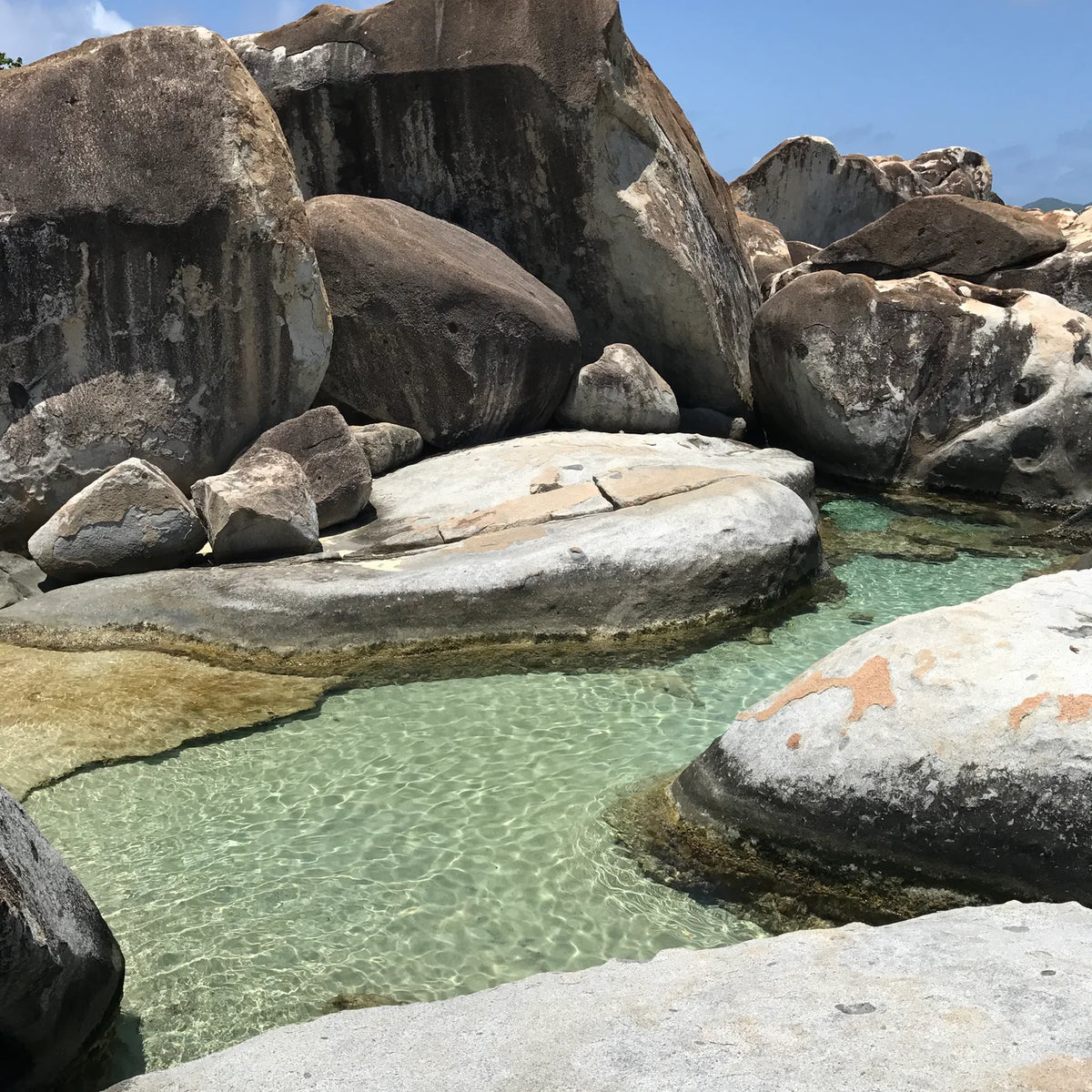 Clear natural pool surrounded by massive rounded granite boulders at The Baths on Virgin Gorda.