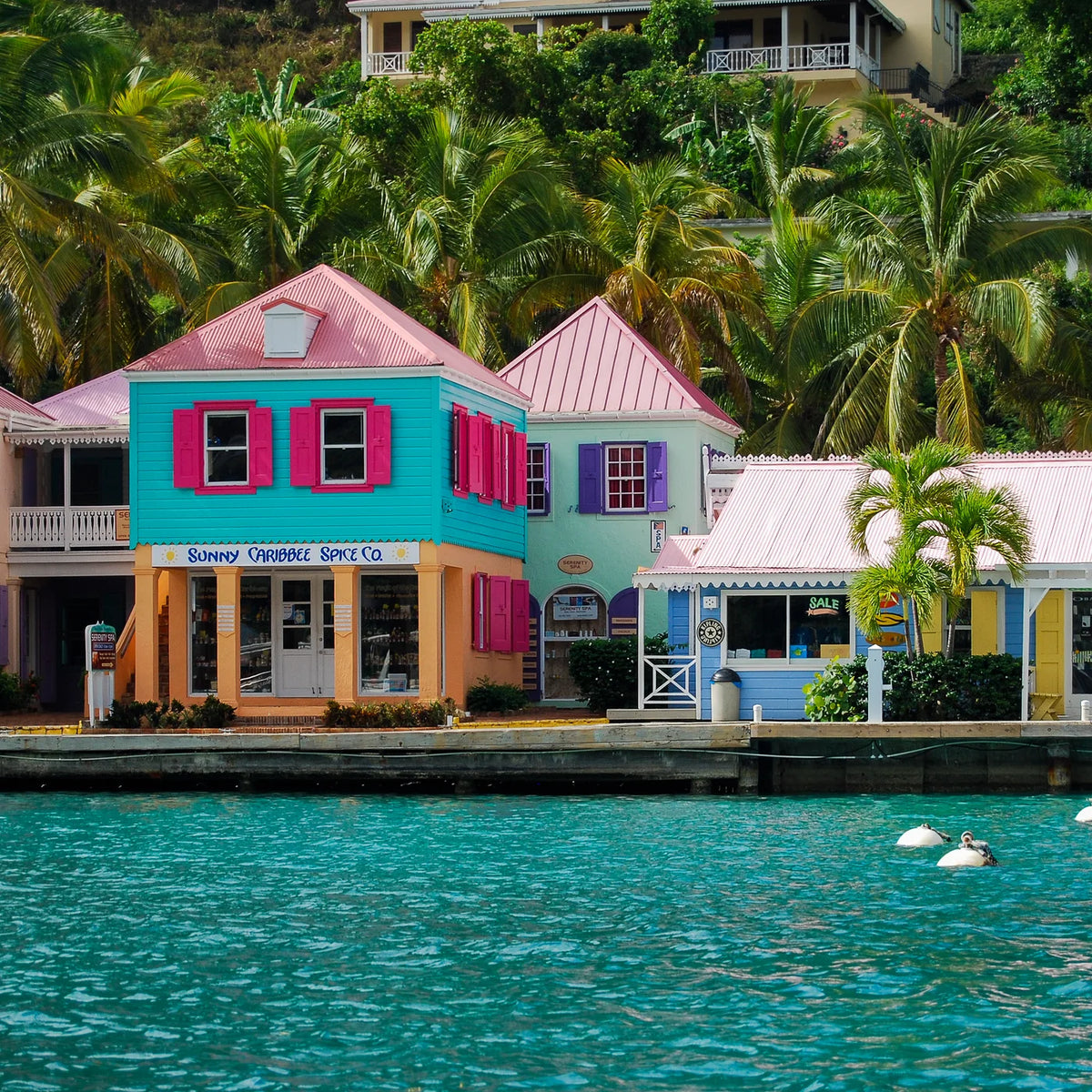 Colorful waterfront buildings beside turquoise water at Soper’s Hole marina on Tortola.