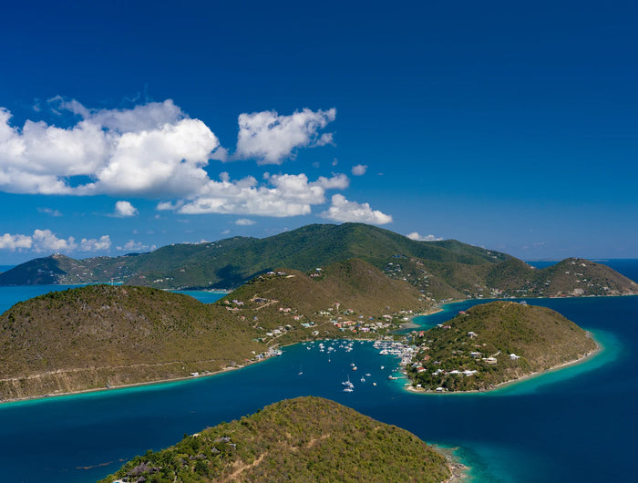 Aerial view of Soper’s Hole harbor, marina, and surrounding hills on Tortola in the British Virgin Islands.