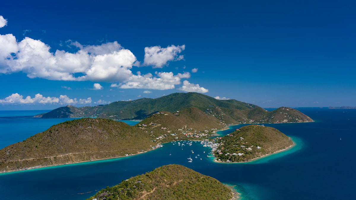 Aerial view of Soper’s Hole harbor, marina, and surrounding hills on Tortola in the British Virgin Islands.