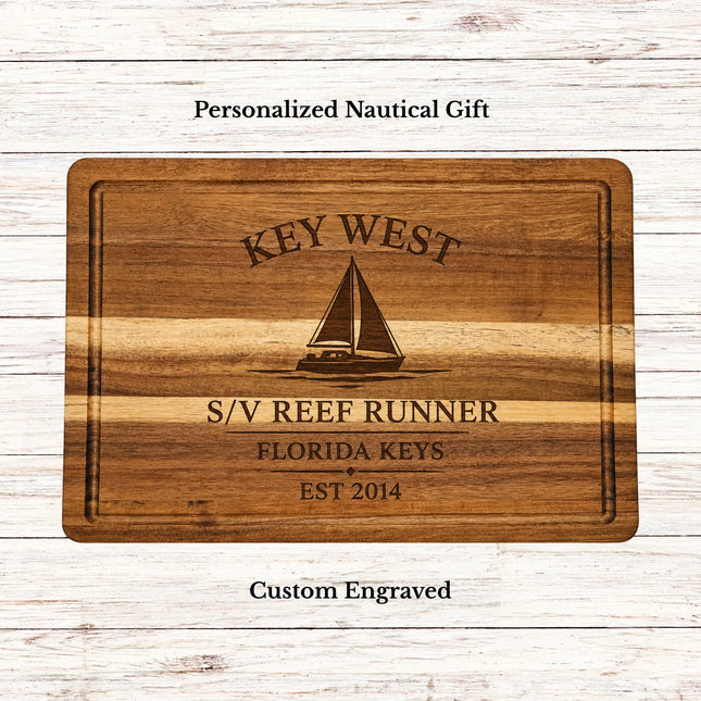 Personalized Harbor Collection acacia wood cutting board featuring a custom home port design with harbor name, sailboat graphic, family or boat name, region, and established year.