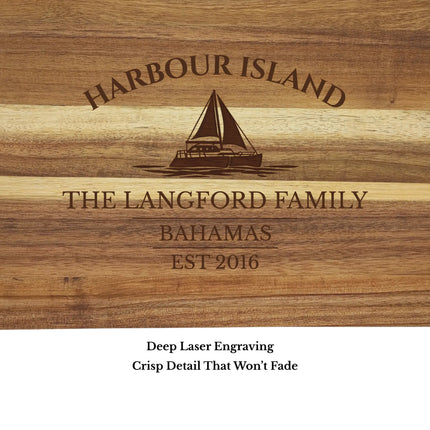 Close up of Harbour Island Bahamas sailboat cutting board engraving showing detailed sailboat design and acacia wood grain