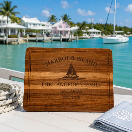 Harbour Island Bahamas sailboat cutting board overlooking calm turquoise harbor water with pastel island cottages and tropical waterfront scenery