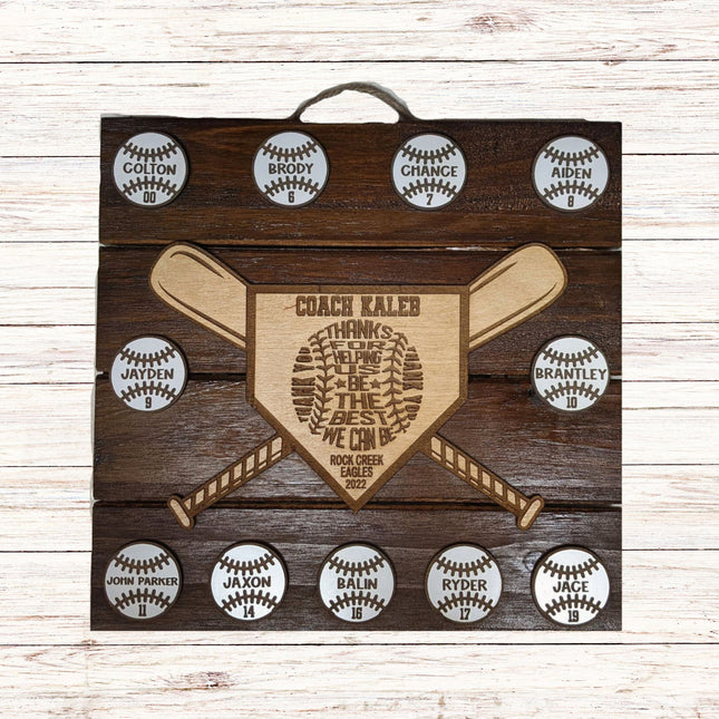 Wooden plaque with engraved text and baseball designs on a wooden background
