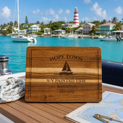Hope Town Bahamas sailboat cutting board overlooking turquoise harbor water with colorful cottages and the iconic striped lighthouse on Elbow Cay