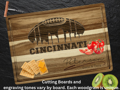 Custom Cincinnati football cutting board featuring the city skyline and a football design. Personalized as requested to make a great gift.