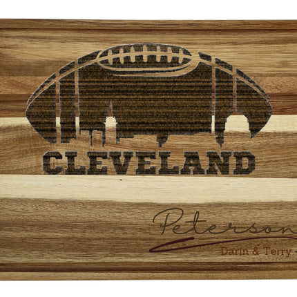 Custom Cleveland football cutting board featuring the city skyline and a football design. Personalized as requested to make a great gift.