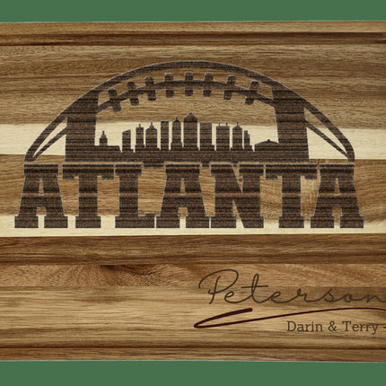 Custom Atlanta football cutting board featuring the city skyline and a football design. Personalized as requested to make a great gift.