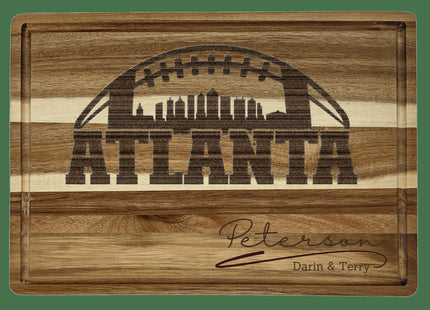 Custom Atlanta football cutting board featuring the city skyline and a football design. Personalized as requested to make a great gift.