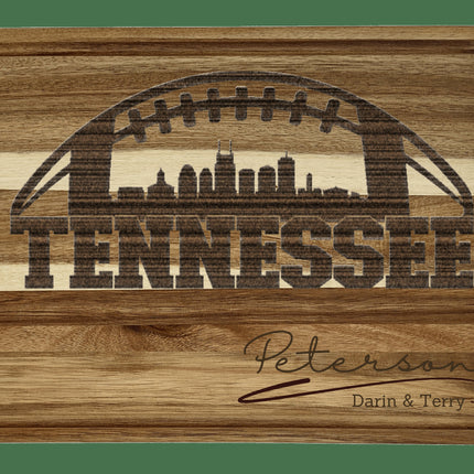 Custom Tennessee football cutting board featuring the city skyline and a football design. Personalized as requested to make a great gift.