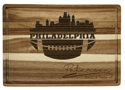 Custom Philadelphia football cutting board featuring the city skyline and a football design. Personalized as requested to make a great gift.
