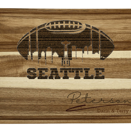 Custom Seattle football cutting board featuring the city skyline and a football design. Personalized as requested to make a great gift.