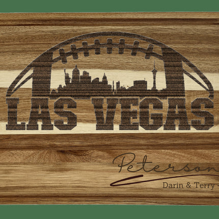 Custom Las Vegas football cutting board featuring the city skyline and a football design. Personalized as requested to make a great gift.