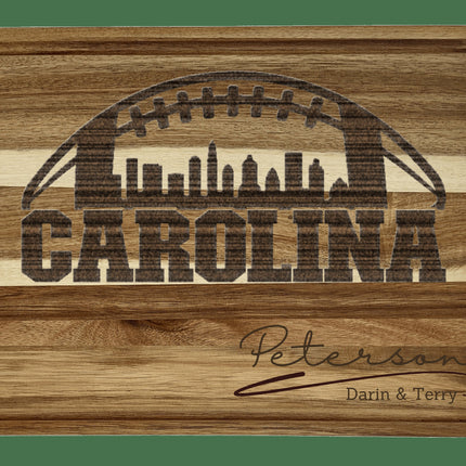 Custom Carolina football cutting board featuring the city skyline and a football design. Personalized as requested to make a great gift.