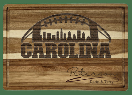 Custom Carolina football cutting board featuring the city skyline and a football design. Personalized as requested to make a great gift.