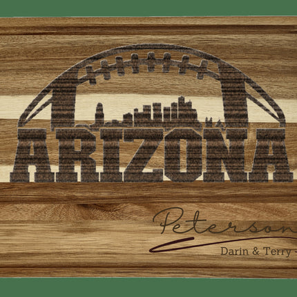 Custom Arizona football cutting board featuring the city skyline and a football design. Personalized as requested to make a great gift.