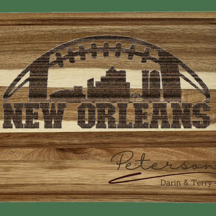 Custom New Orleans football cutting board featuring the city skyline and a football design. Personalized as requested to make a great gift.
