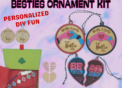 A colorful product display for a “Besties Ornament Kit.” The image shows wooden ornaments in round and heart shapes, some unfinished and others painted in pink, blue, and red with engraved text like “Britta & Carly – In My Bestie Era” and “Best Friends.” A green holiday box contains paint pots, a brush, glue, and twine for hanging. The background is pastel pink and blue with bold text reading “BESTIES ORNAMENT KIT” and “PERSONALIZED DIY FUN.”