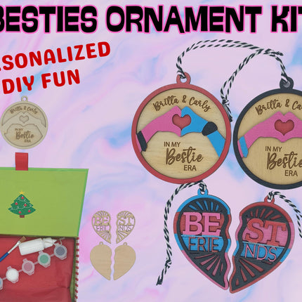 A colorful product display for a “Besties Ornament Kit.” The image shows wooden ornaments in round and heart shapes, some unfinished and others painted in pink, blue, and red with engraved text like “Britta & Carly – In My Bestie Era” and “Best Friends.” A green holiday box contains paint pots, a brush, glue, and twine for hanging. The background is pastel pink and blue with bold text reading “BESTIES ORNAMENT KIT” and “PERSONALIZED DIY FUN.”