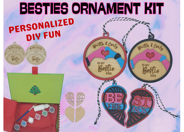 A colorful product display for a “Besties Ornament Kit.” The image shows wooden ornaments in round and heart shapes, some unfinished and others painted in pink, blue, and red with engraved text like “Britta & Carly – In My Bestie Era” and “Best Friends.” A green holiday box contains paint pots, a brush, glue, and twine for hanging. The background is pastel pink and blue with bold text reading “BESTIES ORNAMENT KIT” and “PERSONALIZED DIY FUN.”
