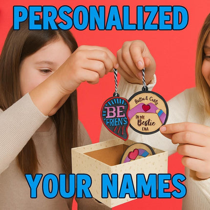 A woman and a young girl smile as they hold up personalized wooden best friend ornaments in front of a bright red holiday background. The woman holds a round ornament engraved with “Britta & Carly – In My Bestie Era,” while the girl holds a half-heart ornament labeled “BE FRIEN’S.” A decorative gift box sits on the table with more ornaments inside, and festive decorations like pine branches, candy canes, and ornaments line the left side. Blue text reads “PERSONALIZED YOUR NAMES.”