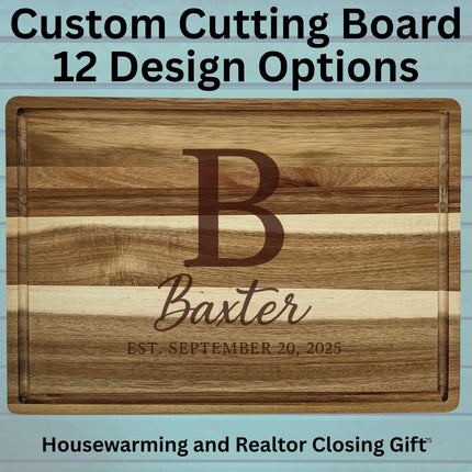 Custom engraved acacia wood cutting board with a large letter “B,” the name “Baxter,” and the text “Est. September 20, 2025.” The background features light blue wooden planks. Text above the board reads “Custom Cutting Board – 12 Design Options,” and text below reads “Housewarming and Realtor Closing Gift.”