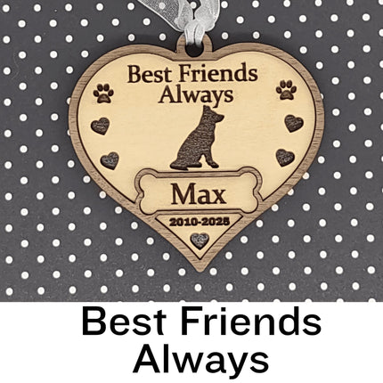 Heart-shaped wooden dog memorial ornament engraved with “Best Friends Always,” featuring a dog silhouette, paw prints, and hearts. The ornament includes the name “Max” and dates “2010–2025,” with a white ribbon for hanging, displayed against a black background with white polka dots. Text below reads “Best Friends Always.”