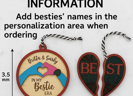 Informational image showing customer order instructions for a personalized Besties Ornament Kit. The text reads “Customer Order Information – Add besties’ names in the personalization area when ordering.” Below the text are two wooden ornaments: one round ornament engraved with “Britta & Sarly – In My Bestie Era” featuring painted pink and blue hands forming a heart, and a split heart ornament labeled “Best Friends.” A 3.5 mm size reference arrow is shown beside the round ornament.