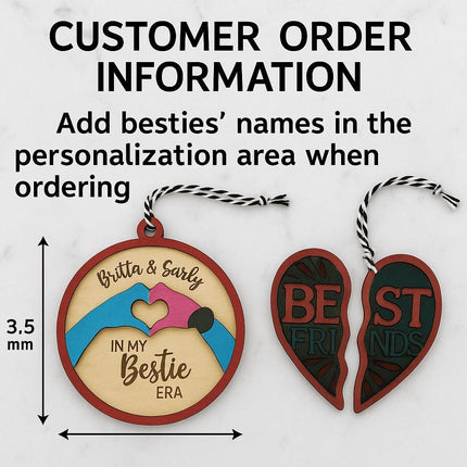 Informational image showing customer order instructions for a personalized Besties Ornament Kit. The text reads “Customer Order Information – Add besties’ names in the personalization area when ordering.” Below the text are two wooden ornaments: one round ornament engraved with “Britta & Sarly – In My Bestie Era” featuring painted pink and blue hands forming a heart, and a split heart ornament labeled “Best Friends.” A 3.5 mm size reference arrow is shown beside the round ornament.