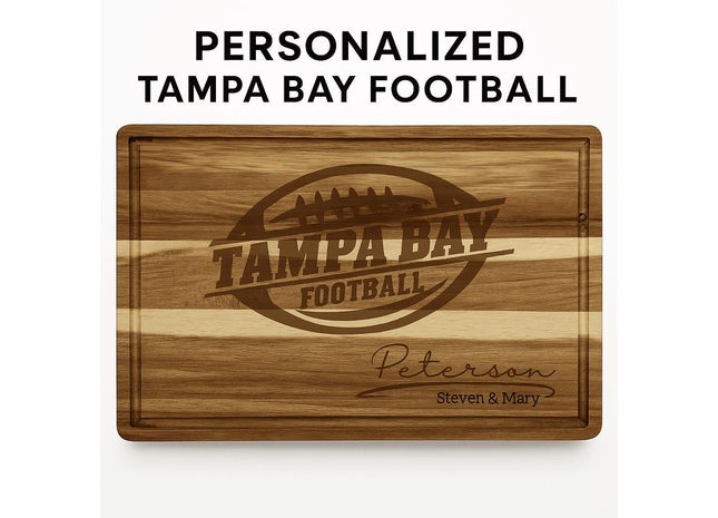 Personalized acacia wood cutting board engraved with a football logo and the text “Tampa Bay Football,” along with the family name “Peterson” and “Steven & Mary” in script at the bottom right. The board features natural striped wood grain and a carved juice groove, displayed against a white background with the words “PERSONALIZED TAMPA BAY FOOTBALL” above it.