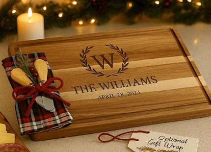 &quot;Personalized acacia cutting board gift set with holiday plaid towel and two cheese spreaders, engraved with the family name and established date. Displayed on a neutral background with decorative greenery, showing components included in the gift set.&quot;