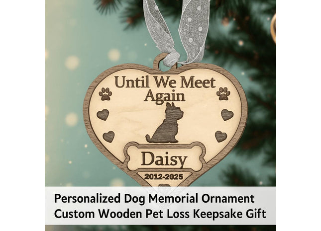 Heart-shaped wooden dog memorial ornament engraved with “Until We Meet Again,” featuring a dog silhouette, paw prints, hearts, and the name “Daisy” with dates “2012–2025.” The ornament hangs from a silver ribbon on a softly lit Christmas tree background. Text below reads “Personalized Dog Memorial Ornament – Custom Wooden Pet Loss Keepsake Gift.”