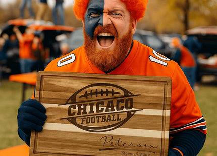 “Excited football fan with orange wig and face paint holding a personalized Chicago football cutting board at a tailgate party. The engraved acacia board features a football logo and the name ‘Peterson – Steven & Mary.’ The fan wears a bright orange jersey, surrounded by fellow supporters and tailgate tables in team colors.”