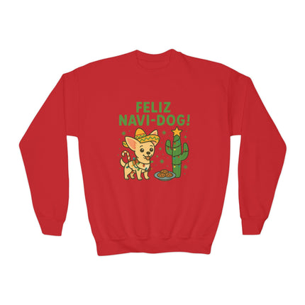 Red crewneck sweatshirt featuring a festive “Feliz Navi-Dog!” Christmas design. The graphic shows a smiling Chihuahua wearing a sombrero and scarf beside a cactus decorated like a Christmas tree with a star on top and a plate of cookies nearby. The phrase “FELIZ NAVI-DOG!” appears above the illustration in bold green letters.