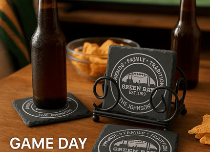 &quot;Personalized Green Bay slate coasters engraved with &#39;Friends • Family • Tradition,&#39; &#39;Green Bay Est. 1919,&#39; and &#39;The Johnsons,&#39; displayed on a wooden table with beer bottles, chips, and a TV showing a football game in the background. Text overlay reads &#39;Game Day Ready – Personalized for Your Family Tradition.&#39;&quot;