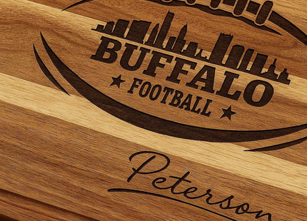 &quot;Close-up of a personalized Buffalo Football cutting board made from premium acacia wood, featuring a detailed laser-engraved football and city skyline design with the name &#39;Peterson&#39; engraved below. Text overlay reads &#39;Premium Acacia Wood · Built to Last,&#39; highlighting the board’s craftsmanship and durability.&quot;