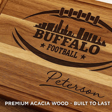"Close-up of a personalized Buffalo Football cutting board made from premium acacia wood, featuring a detailed laser-engraved football and city skyline design with the name 'Peterson' engraved below. Text overlay reads 'Premium Acacia Wood · Built to Last,' highlighting the board’s craftsmanship and durability."