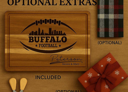 &quot;Buffalo football personalized cutting board shown with included and optional extras. The board is engraved with a football and city skyline design, plus a custom family name. Displayed with two optional cheese spreader knives, an optional plaid kitchen towel, and an optional red gift box with snowflake pattern and ribbon. Text reads &#39;Included & Optional Extras&#39; on a wooden background.&quot;