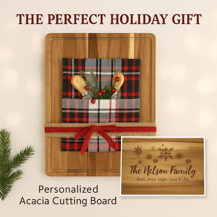 Holiday-themed personalized acacia cutting board displayed as a gift, wrapped with a red and black plaid cloth, small wooden utensils, greenery, and a festive red ribbon. A smaller inset image shows an engraved design with snowflakes and the text “The Nelson Family” along with family member names. The headline reads “THE PERFECT HOLIDAY GIFT” and the caption below says “Personalized Acacia Cutting Board.”