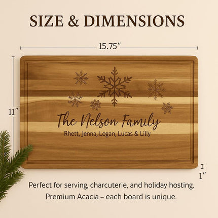 Size and dimensions graphic showing a personalized acacia cutting board with snowflake engraving and “The Nelson Family,” measuring 15.75 inches by 11 inches and 1 inch thick, with a note that it is ideal for serving and charcuterie and that each board’s woodgrain is unique.