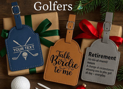 &quot;Three personalized leather golf bag tags displayed on wrapped holiday gifts with green and red ribbons, surrounded by golf tees, a golf ball, and evergreen branches. The navy tag shows crossed golf clubs with customizable text, the tan tag reads &#39;Talk Birdie to me,&#39; and the gray tag defines &#39;Retirement&#39; humorously as &#39;A change of circumstances allowing one to play golf all day — everyday.&#39; Text at the top reads &#39;Perfect Gift for Golfers&#39; with a small Christm