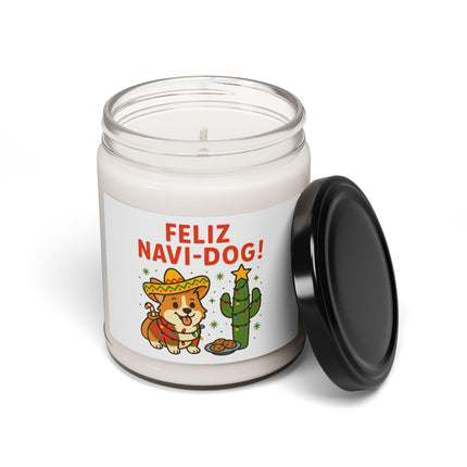 "White glass candle jar with the lid resting beside it, featuring the 'Feliz Navi-Dog!' design of a smiling Corgi in a sombrero next to a cactus decorated with lights and a star topper. The festive candle is displayed on a clean white background."